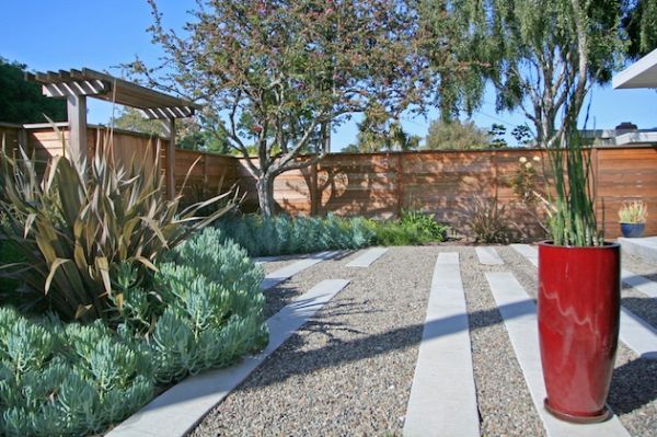 Tall Red Planter Adds a Bold Accent to Gravel Paths