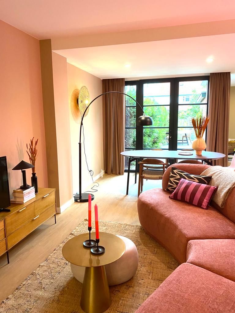 Brass Pedestal Table With Tall Red Candles Adds a Pop of Color
