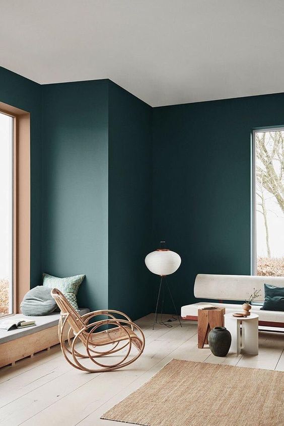 Rattan Rocker Adds Natural Texture To Dark Walls