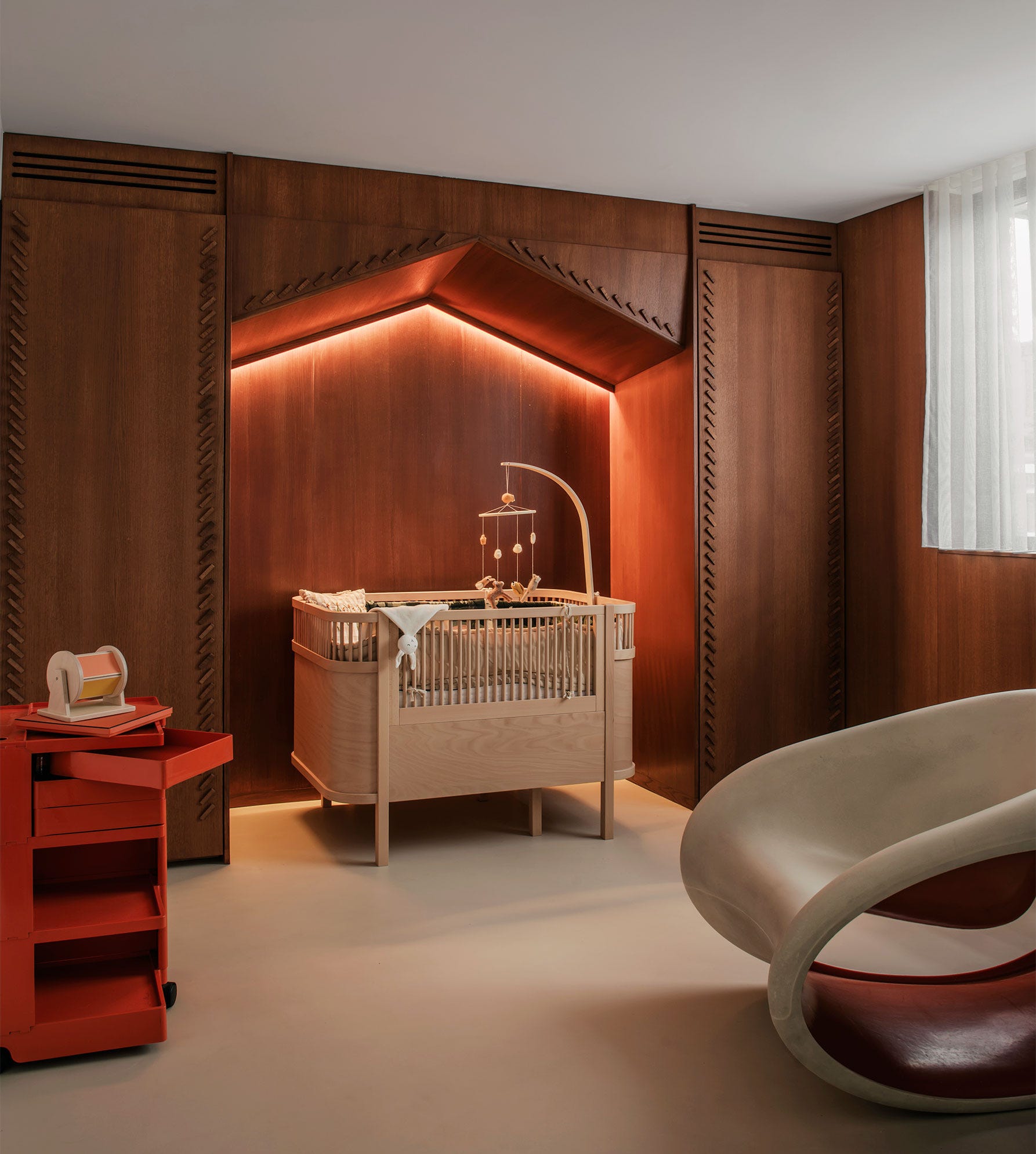 Built-in Niche With Warm Lighting Creates a Cozy Crib Corner