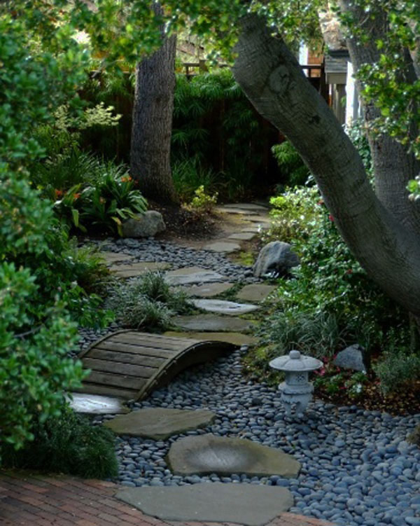 Small Wooden Bridge Over a Pebble Path