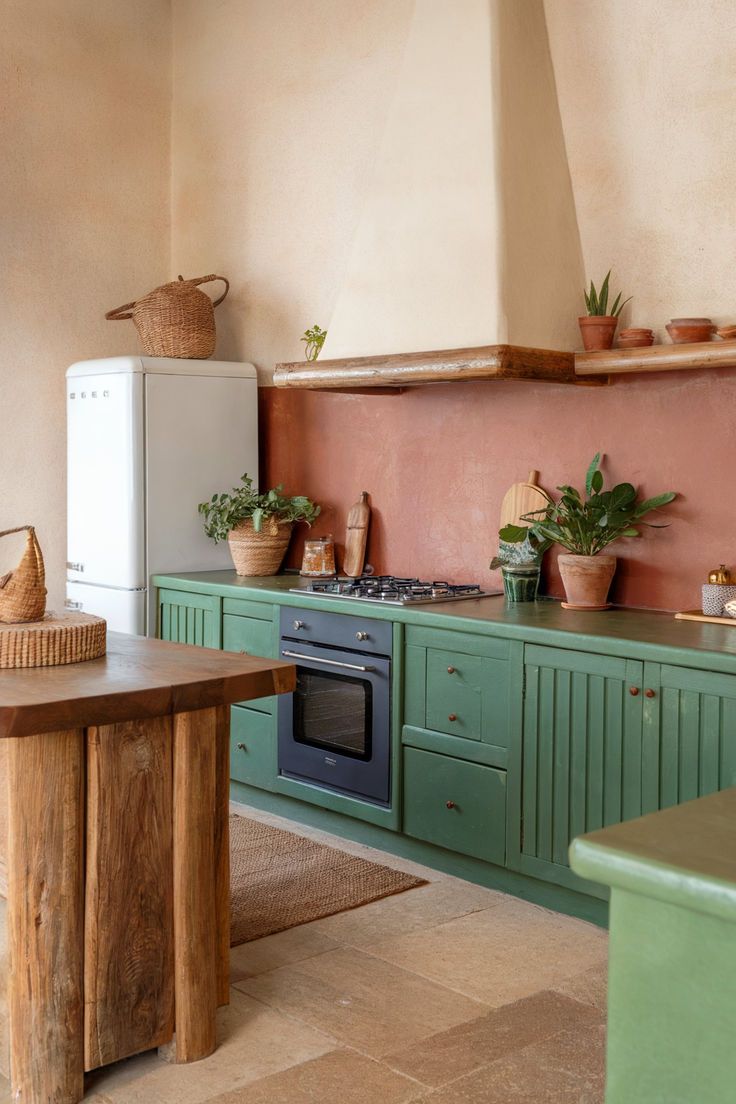Green Kitchen Cabinets Paired with Countertop Plants