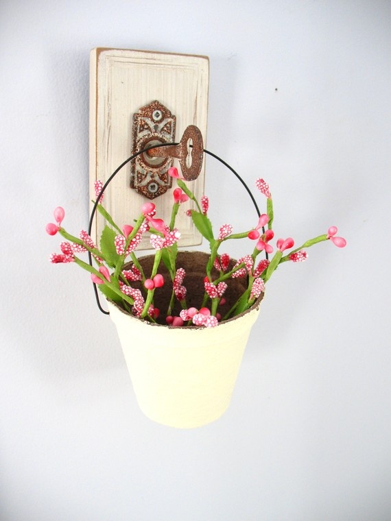 Repurposed Door Plate Holds a Yellow Bucket of Flowers
