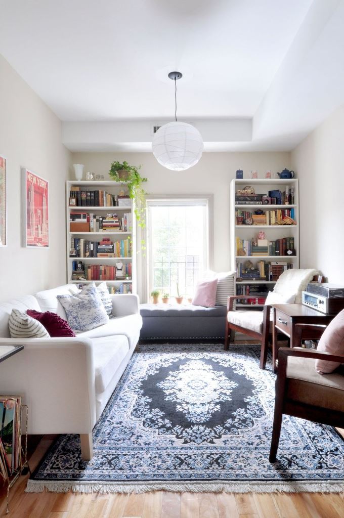 Dark Ottoman Bench With Potted Plants Adds a Cozy Window Seat