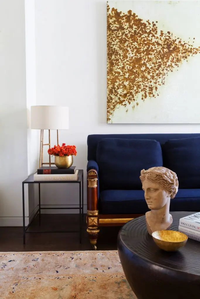 Gold Vase With Bright Orange Flowers Adds a Pop of Color