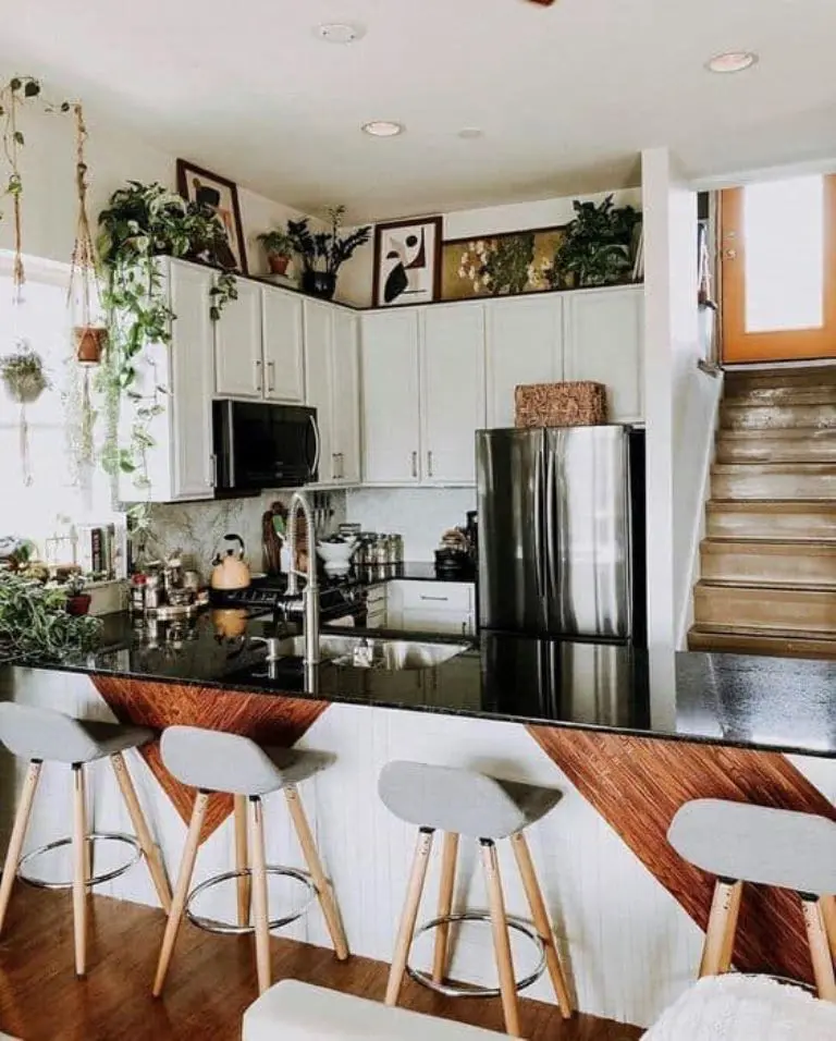 Layer Art and Plants Above Cabinets