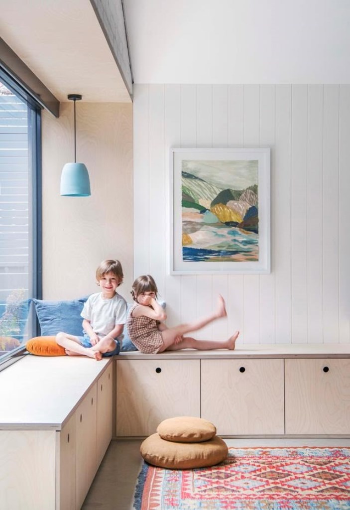Light Wood Cabinets With Integrated Pulls Maximize Window Seat Storage