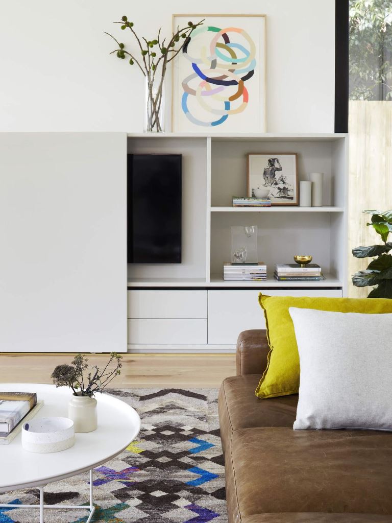 White Cabinet With Sliding Door Hides TV and Offers Open Shelving