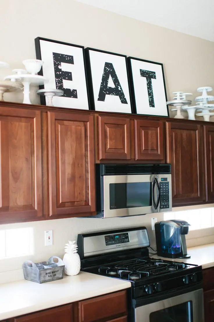 Oversized 'EAT' Letters Add Bold Typography Above Cabinets