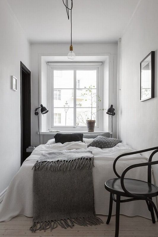 Adjustable Black Sconces Illuminate Bedside Space