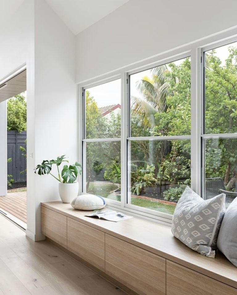 Wooden Cabinet Bench Creates Built-In Window Seating With Hidden Storage