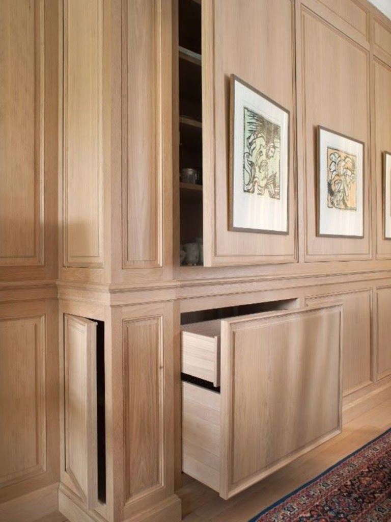 Built-in Drawers Disguise Clutter Behind Wall Paneling