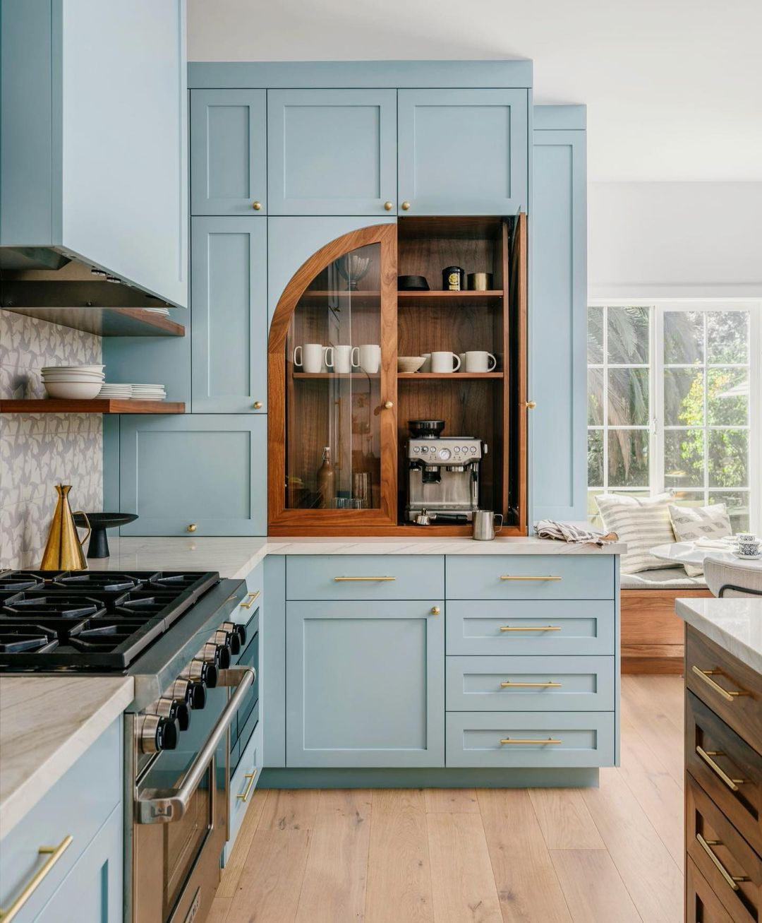 Arched Wood Cabinetry Houses Espresso Machine and Mugs