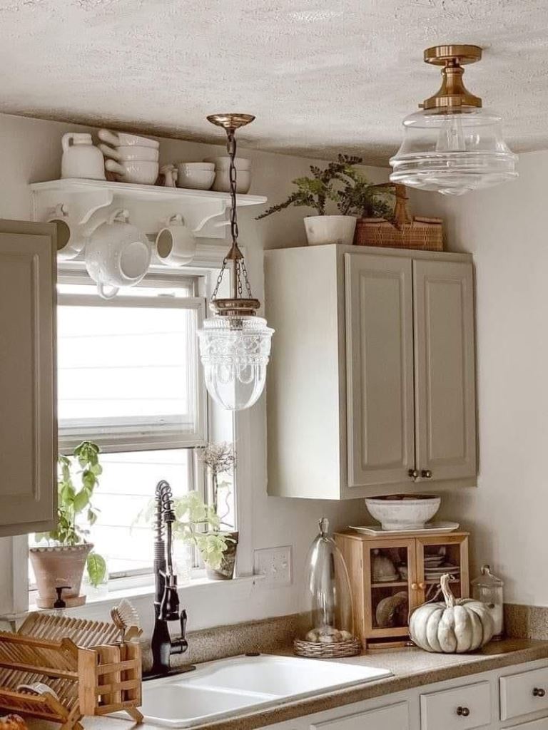 White Shelf Displays Stacked Dishes and Hanging Mugs