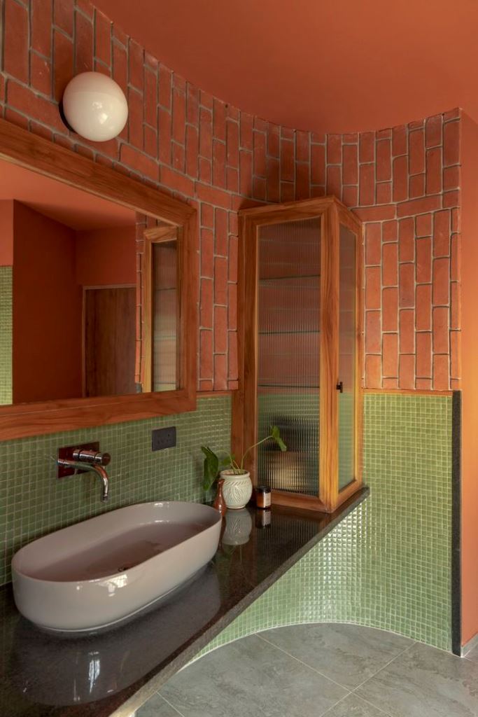 Glass-Fronted Cabinet Adds Warm Texture to Bathroom Counter