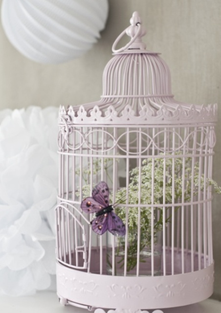 Pastel Bird Cage Displays Delicate White Flowers