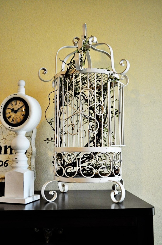 White Bird Cage Filled With Twigs and Greenery