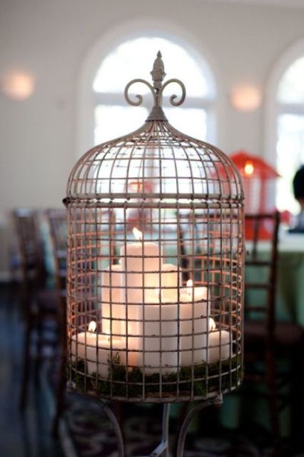 Group Tiered Pillar Candles Inside a Wire Cage