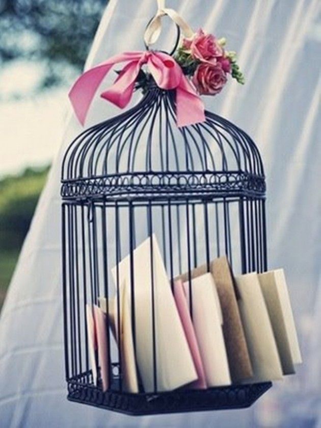 Black Bird Cage Holds Wedding Programs