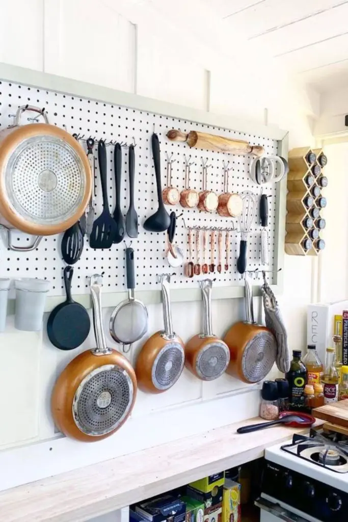 Copper Pots and Pans Hung on Pegboard for Easy Access