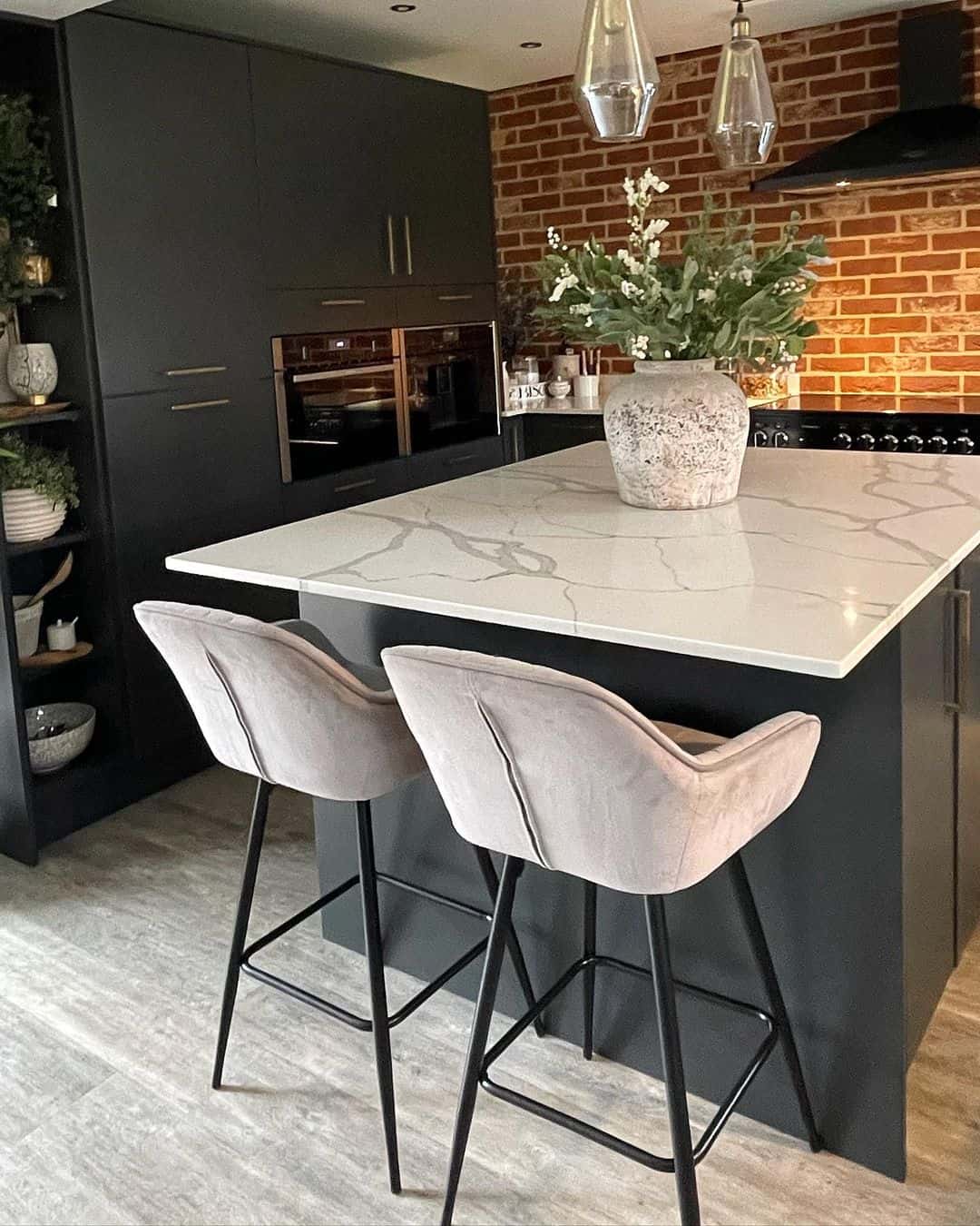 Modern Black Kitchen With Brick Wall